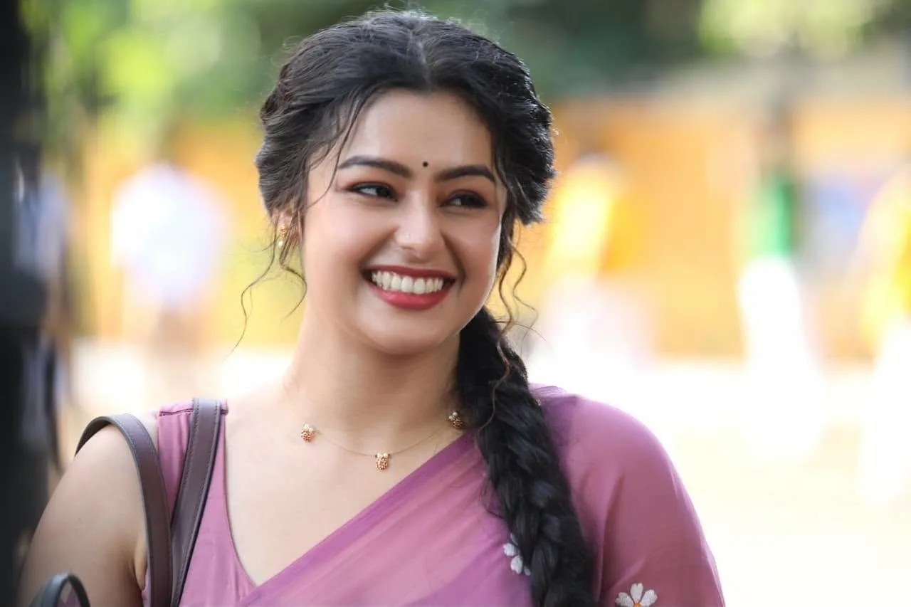 Mokksha smiling in a pink saree with braided hair as Meenu Miss from Gatta Kusthi 2